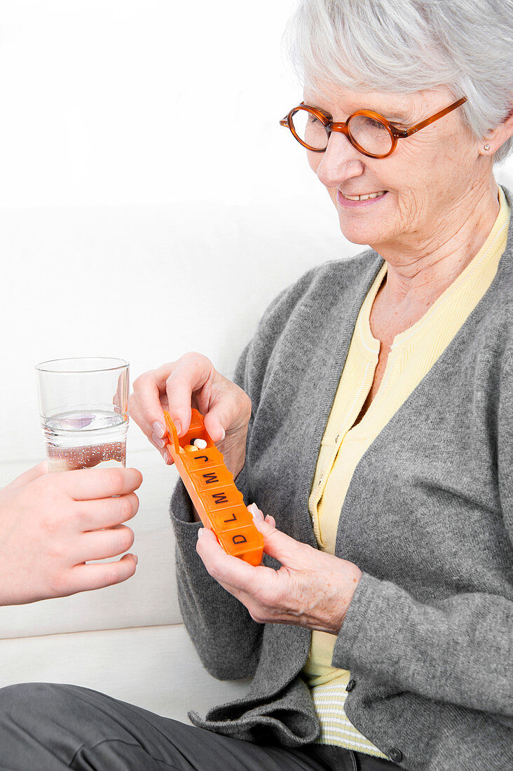 Woman holding pill container