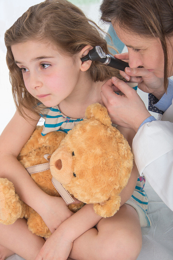 Girl having her ears examined