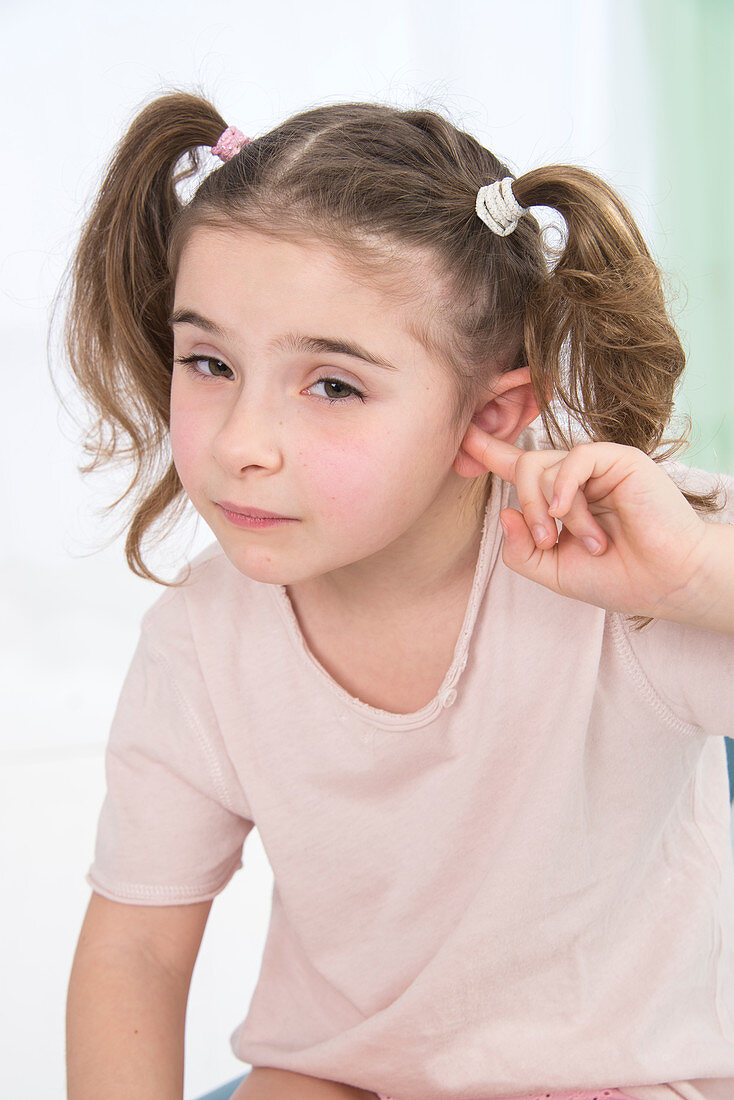 Girl with her finger in her ears