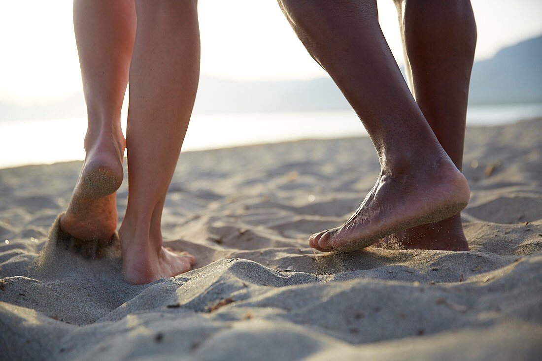 Barefoot couple on beach