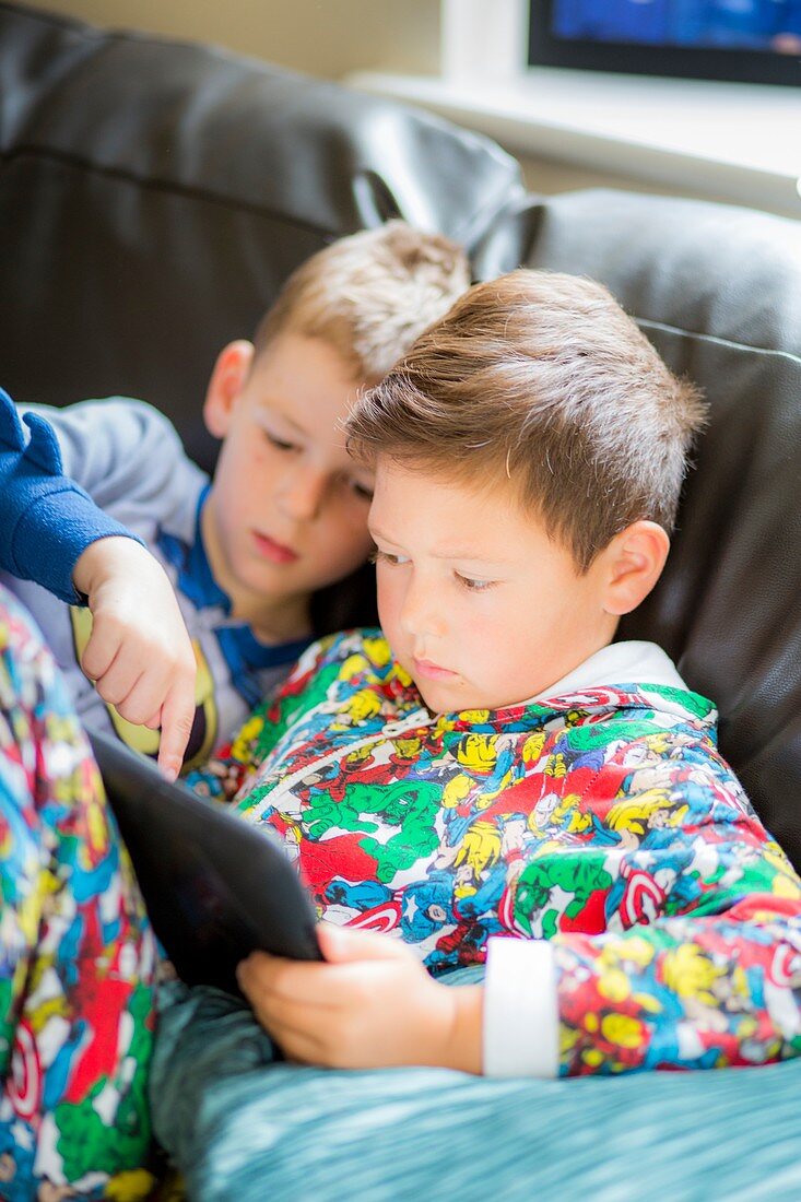 Two boys using a digital tablet