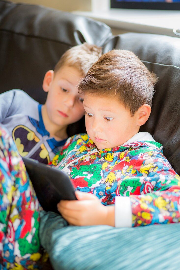 Two boys using a digital tablet