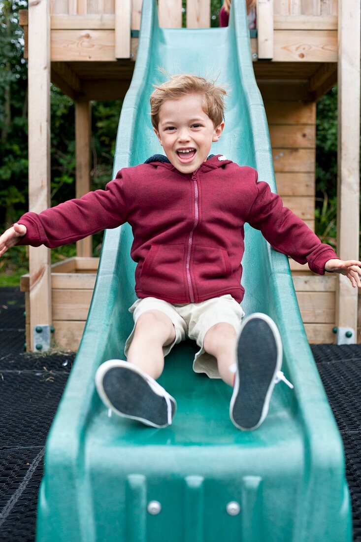 Boy sliding down a slide