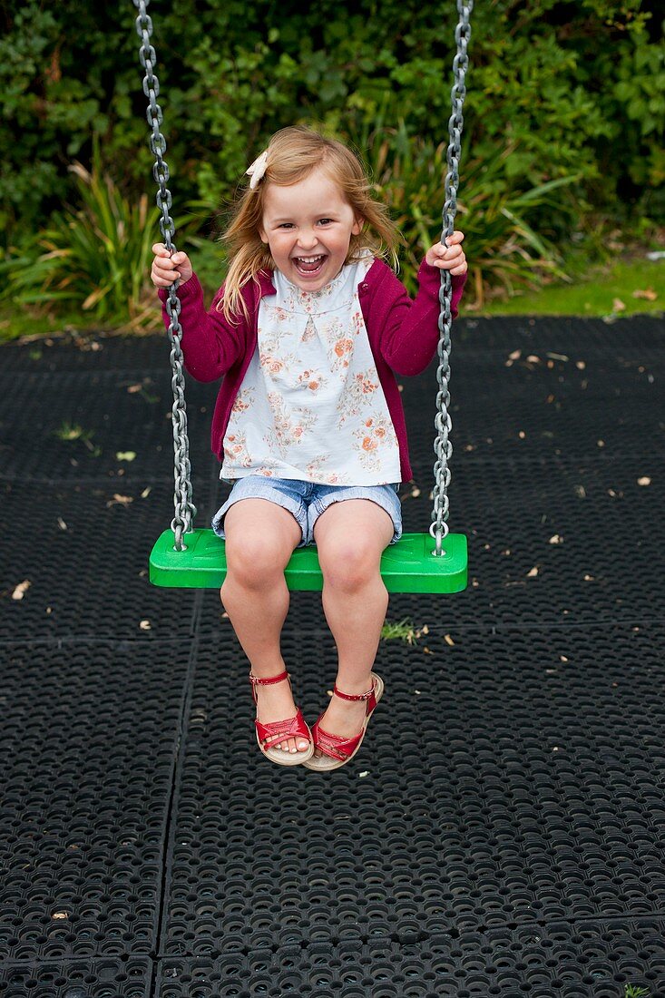 Girl playing on a swing
