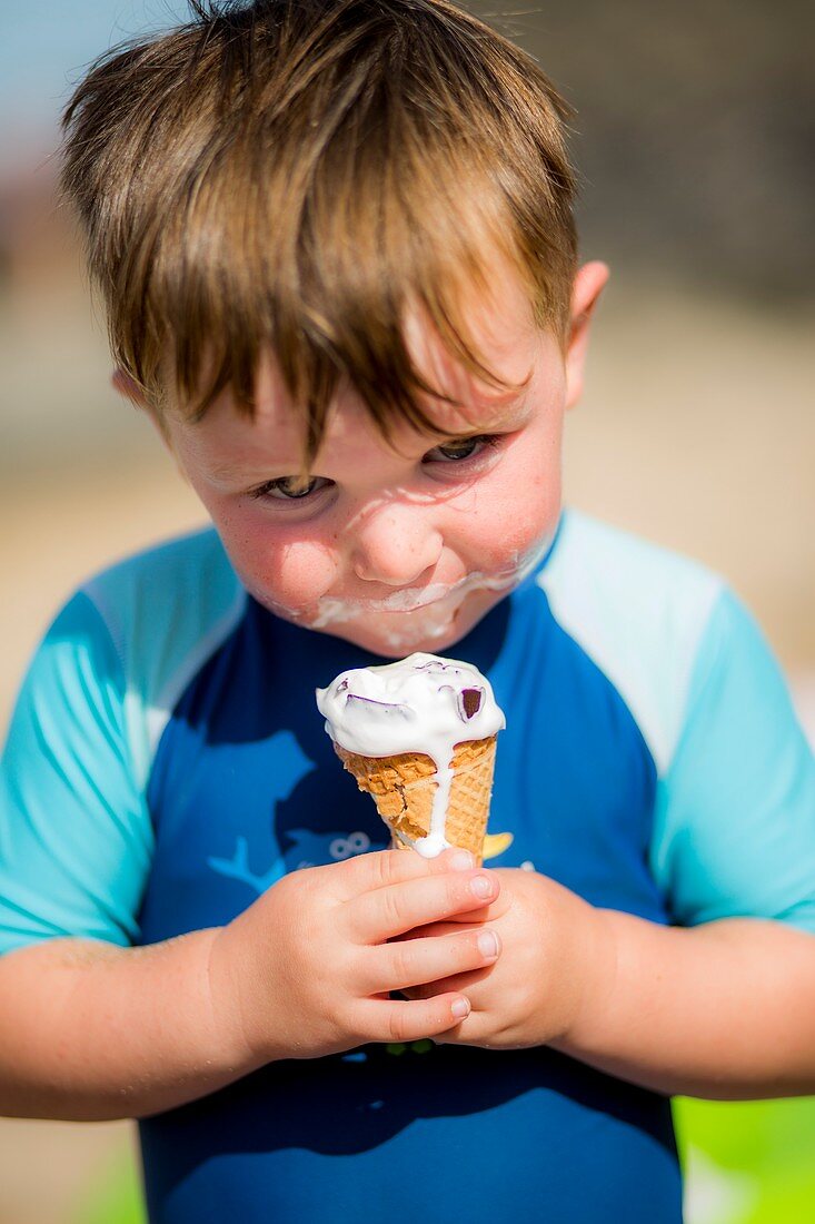 Young boy eating an ice cream