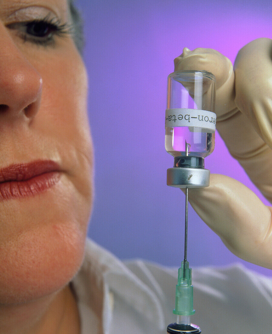 Beta-interferon drug drawn into syringe from vial