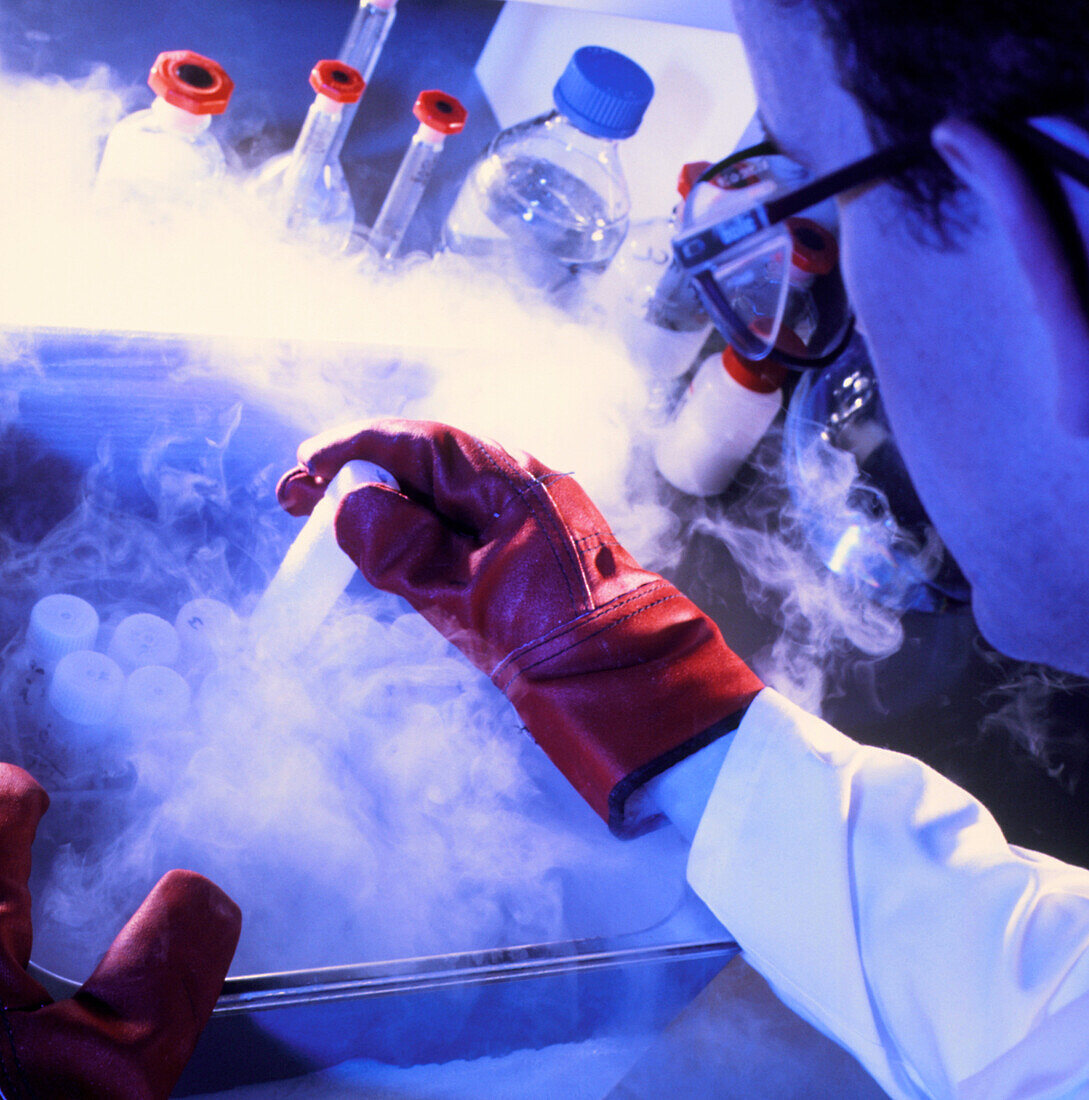 Researcher removing sample tube from cryostorage