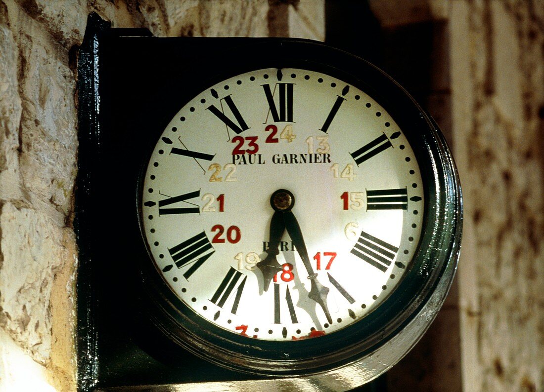 Railway station clock showing 06:27 or 18:27