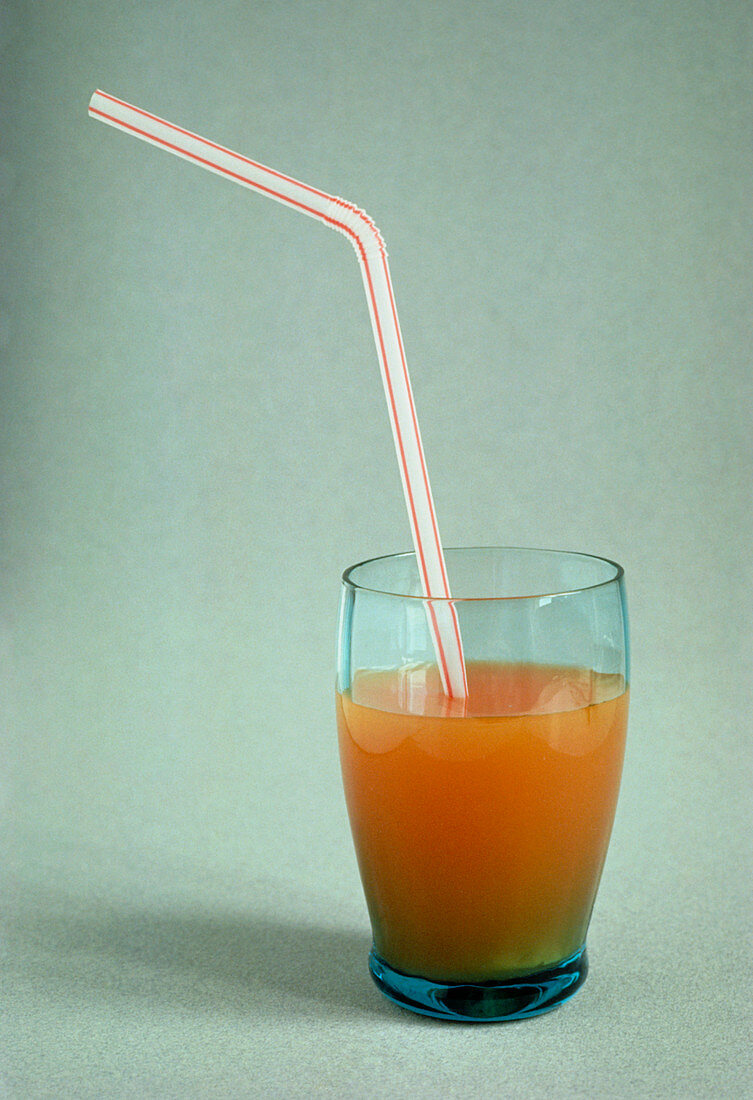 A bent straw in a glass with a soft drink