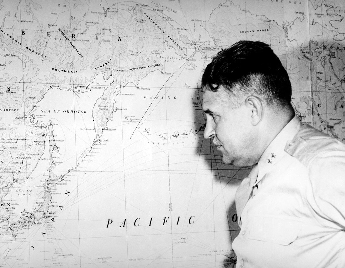Major General Groves studying a map of Japan