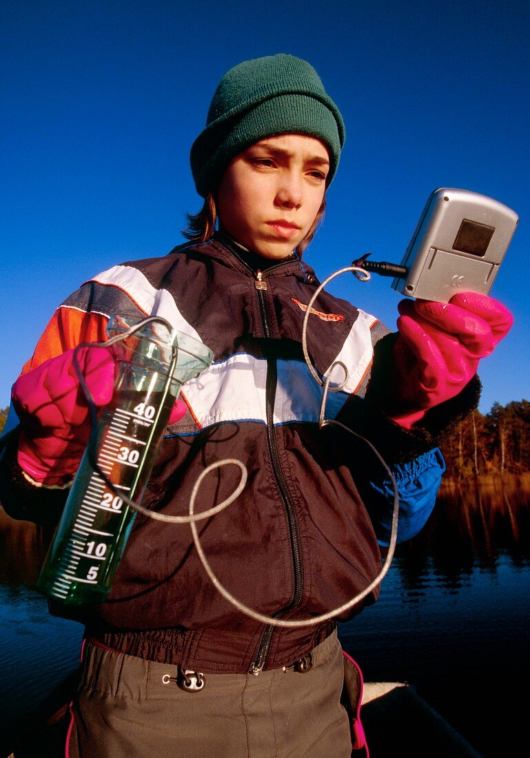 Student measuring water temperature