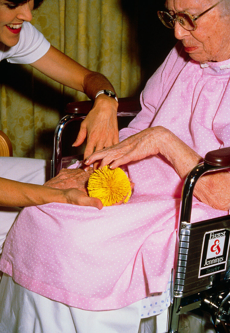 Nurse helping elderly patient with arthritis
