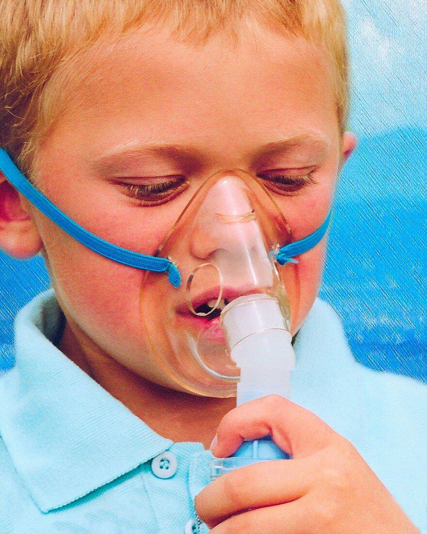 Boy using an inhaler for asthma