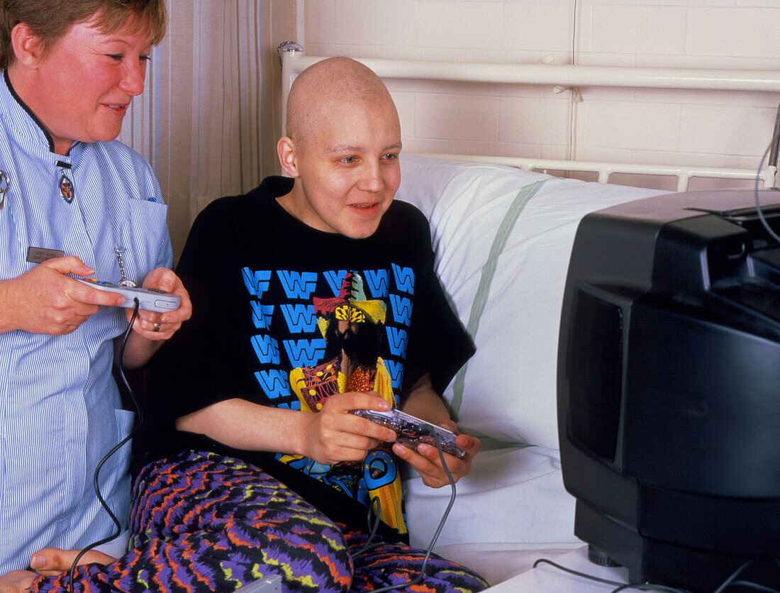 Male cancer patient in hospital plays a video game