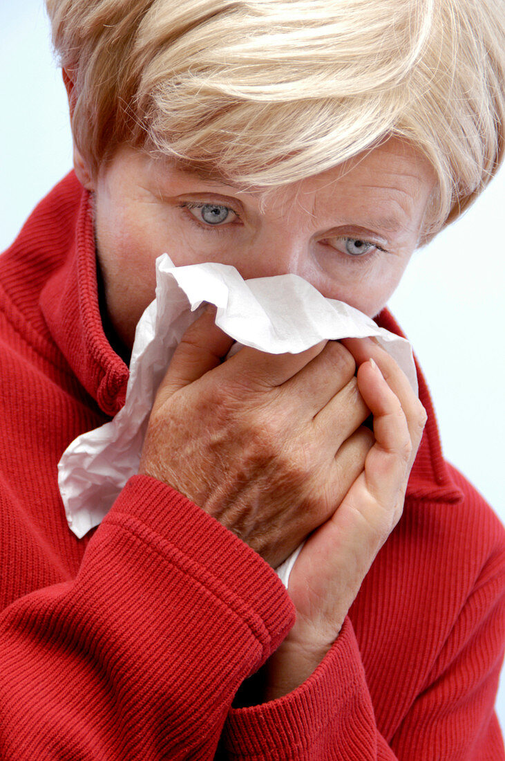 Woman blowing her nose