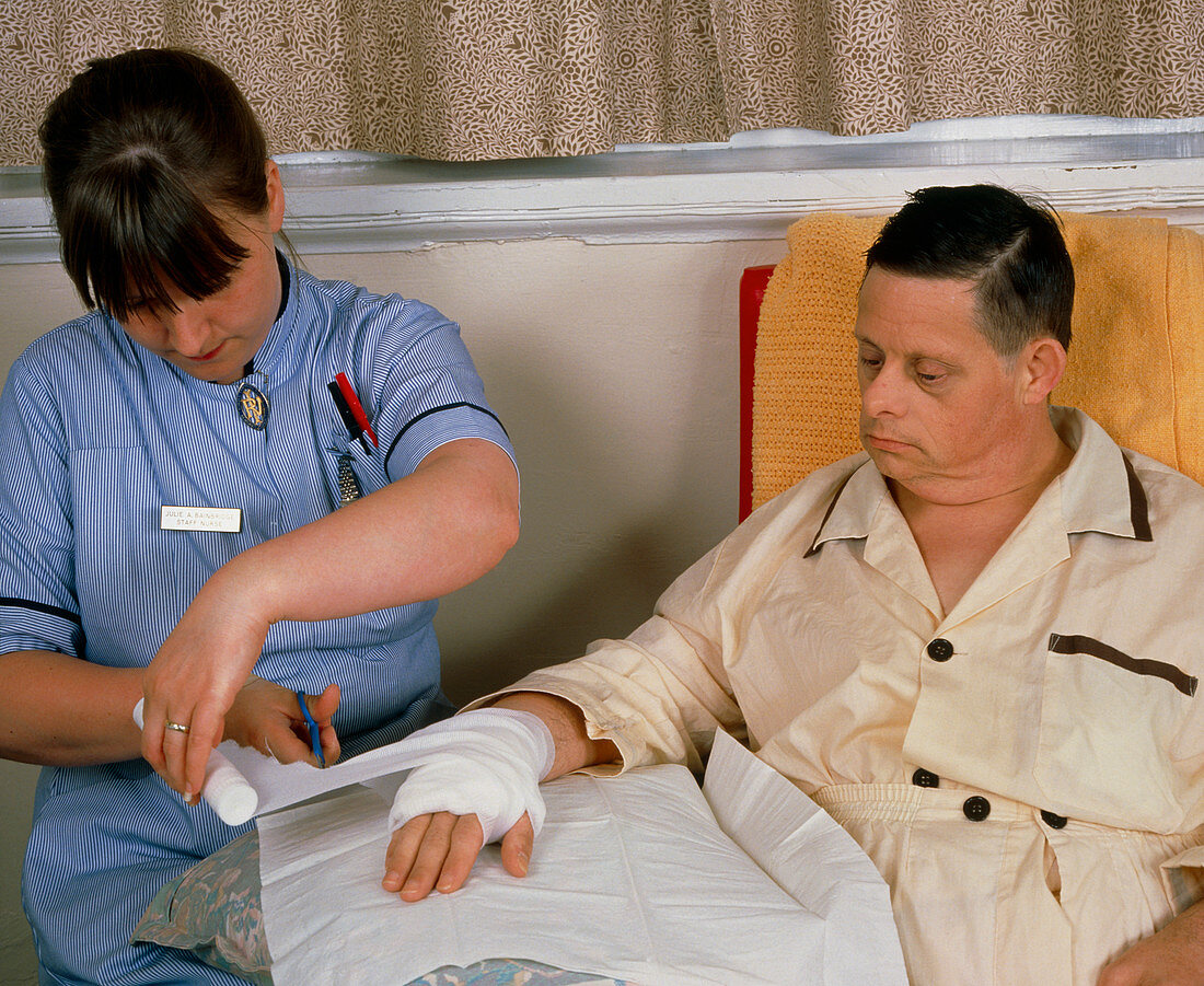 Down's syndrome man with nurse after chemotherapy