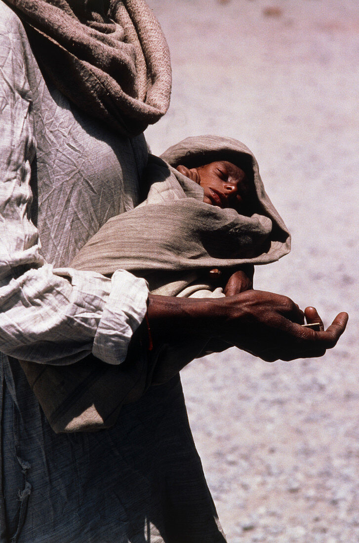 Beggar woman with malnourished infant