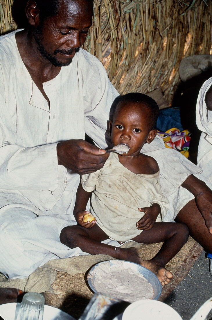Father feeds malnourished son porridge