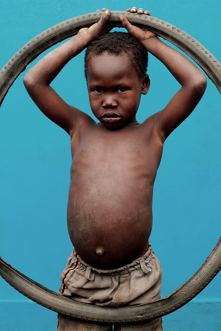 Child with bicycle tyre
