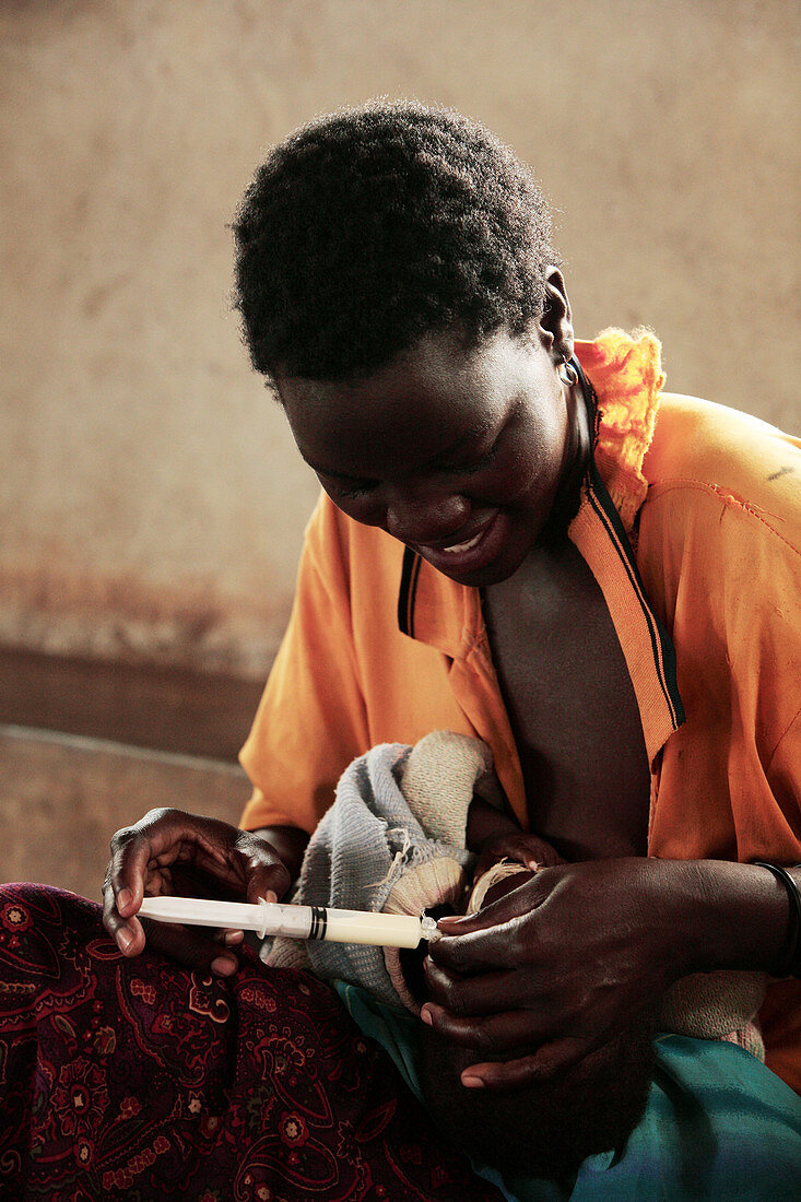 Malnourished child being fed,Uganda
