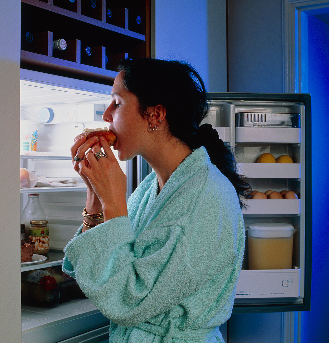 Eating disorder: young woman craving food at night