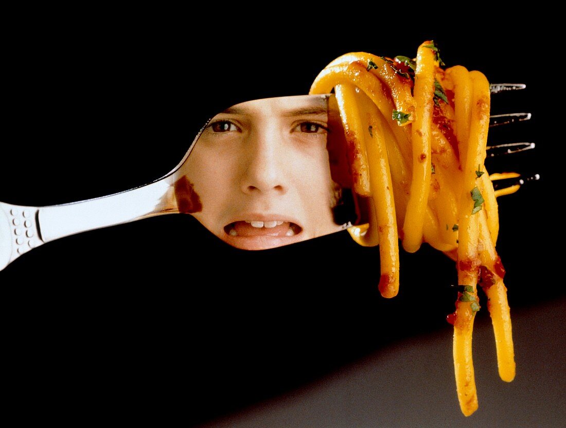Anorexia nervosa: girl reflected in fork with food