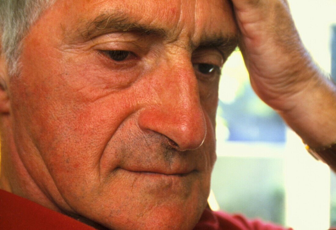 Close-up of a depressed elderly man