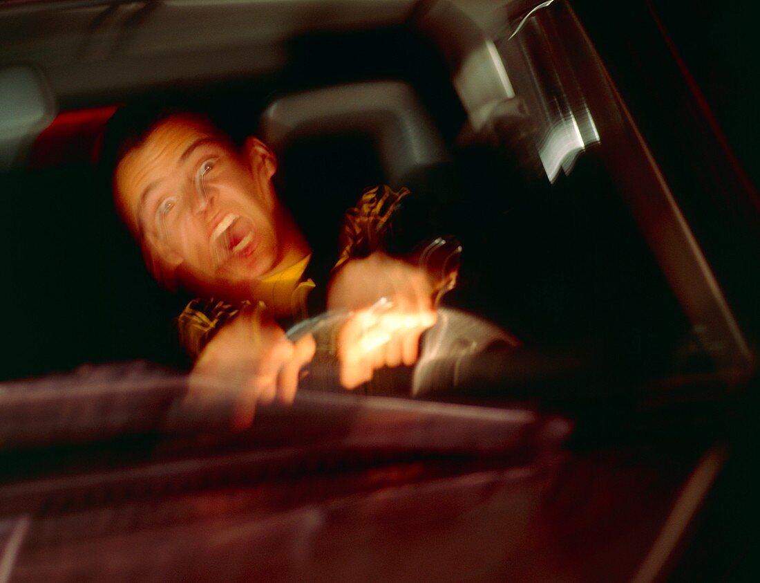 Terrified man driving a car about to crash