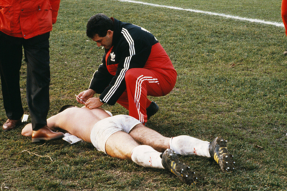 Sportsman receiving treatment