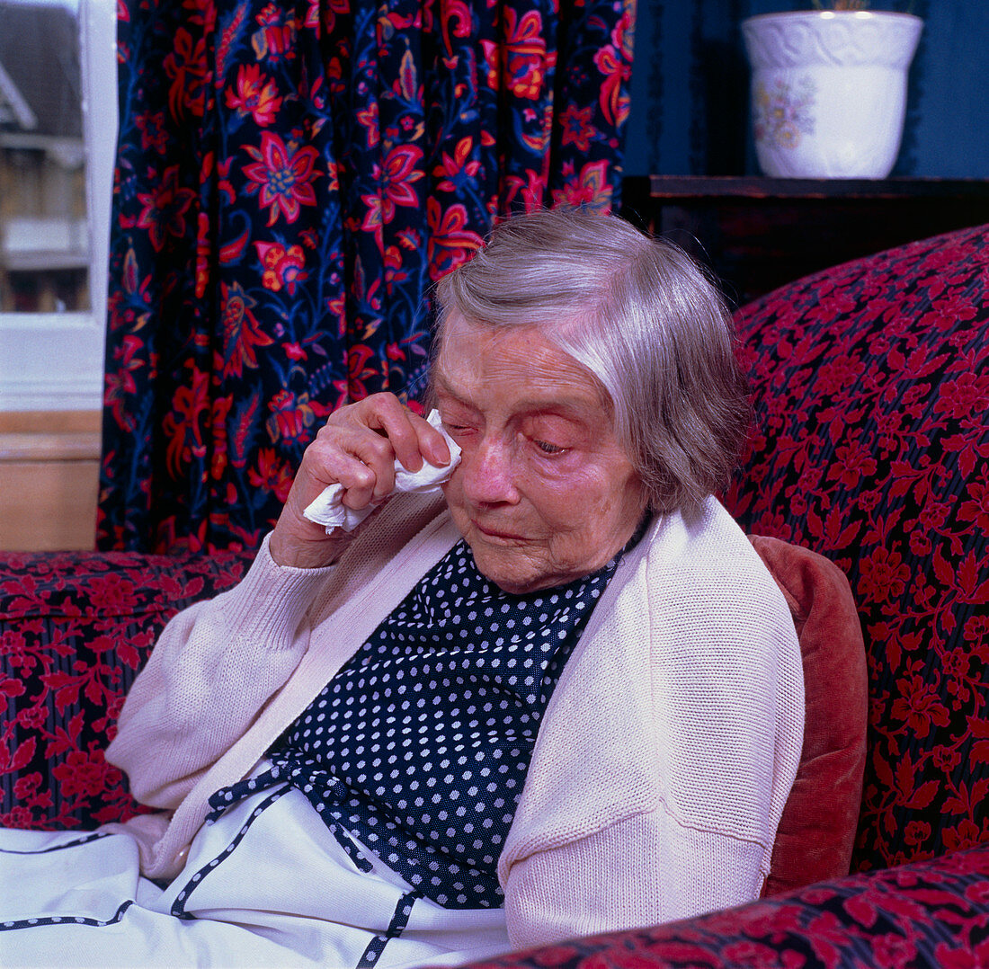 Loneliness in old age; elderly woman weeping