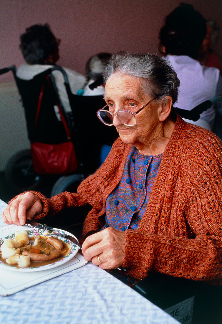 View of an elderly woman eating her dinner