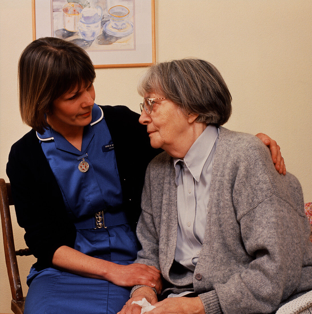 District nurse comforts an elderly patient