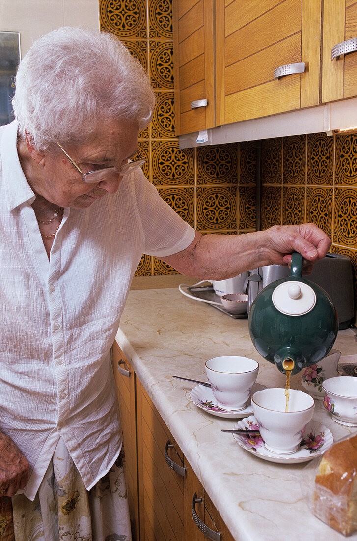 Elderly woman making tea