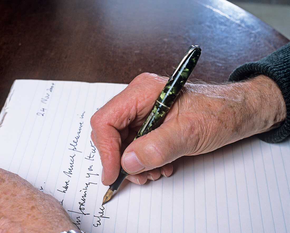 Elderly person writing