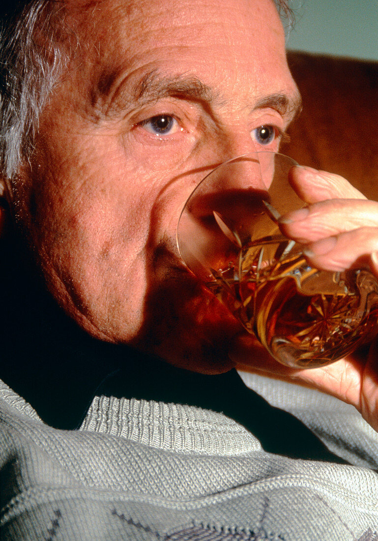 Elderly man drinking alcohol