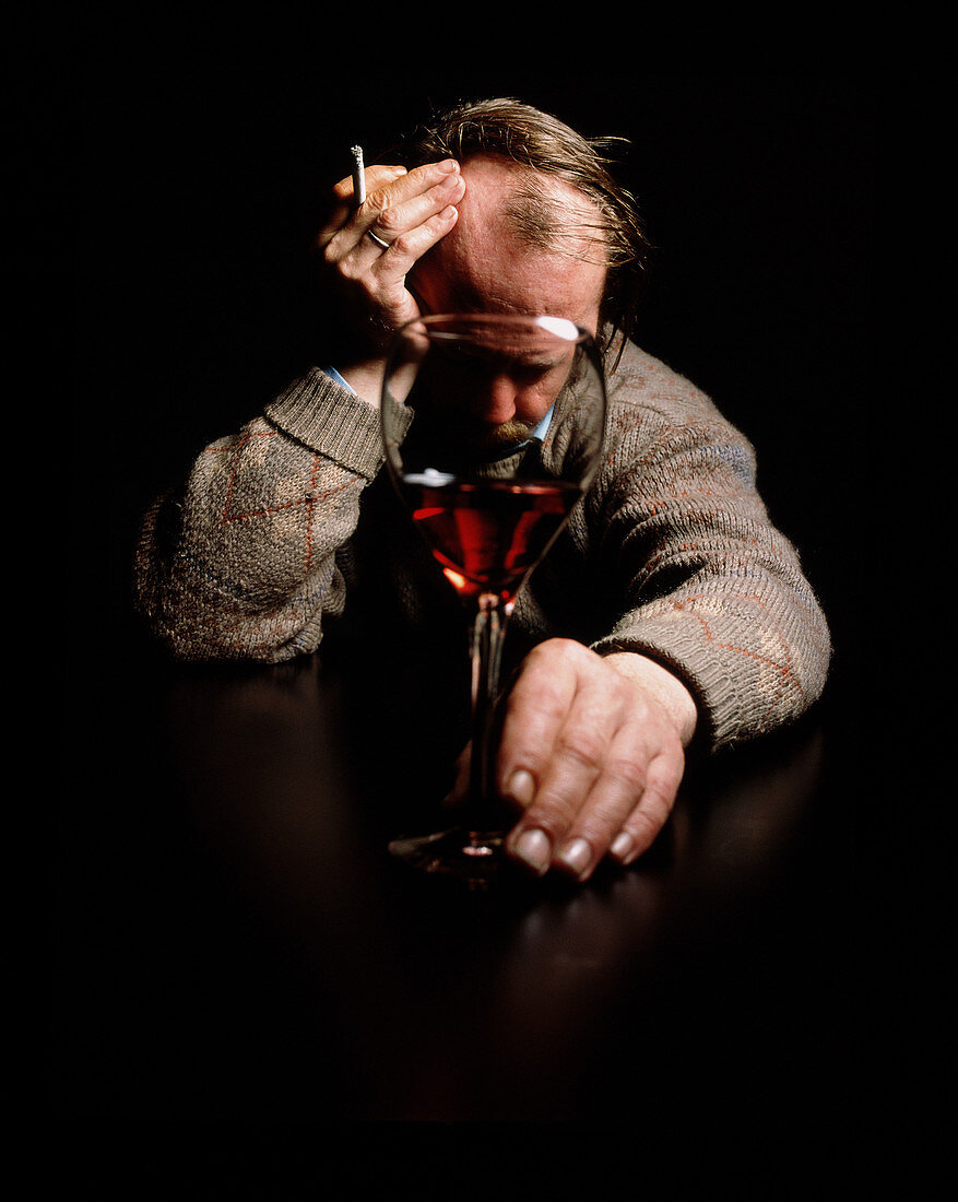 Depressed man with cigarette and alcohol