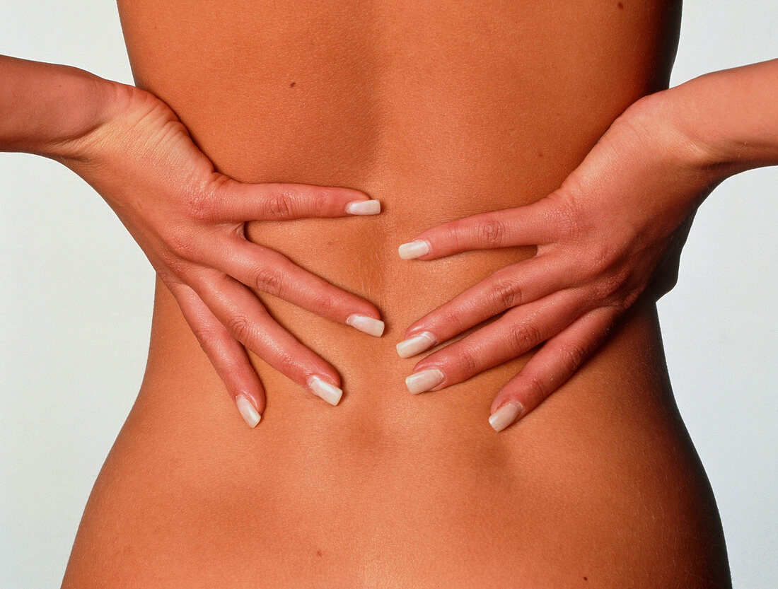 Back pain woman's hands on her lower back