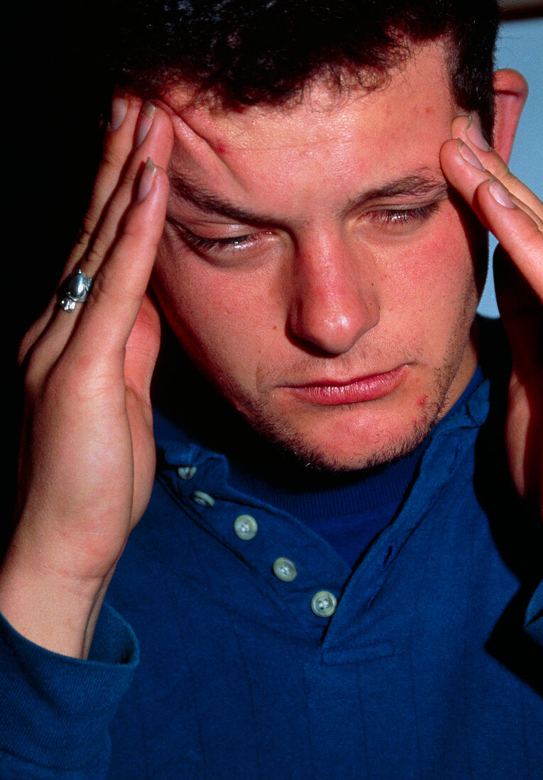 Man suffering the pain of a headache or migraine