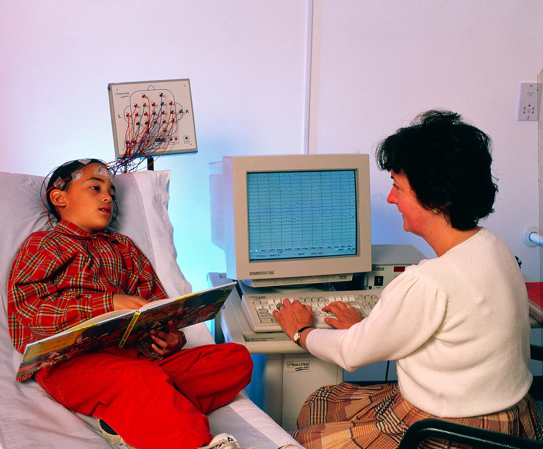 Doctor monitors boy's brain activity by EEG