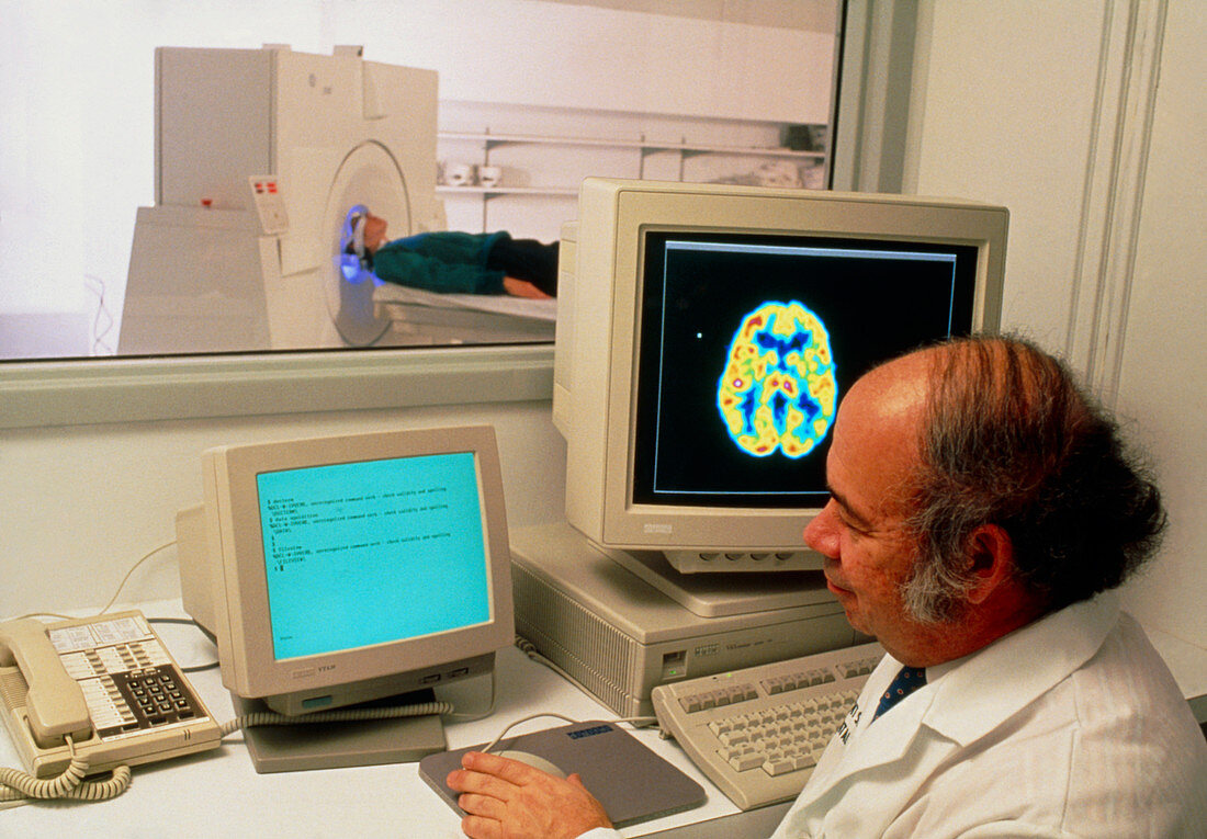 Radiographer performing a PET brain scan