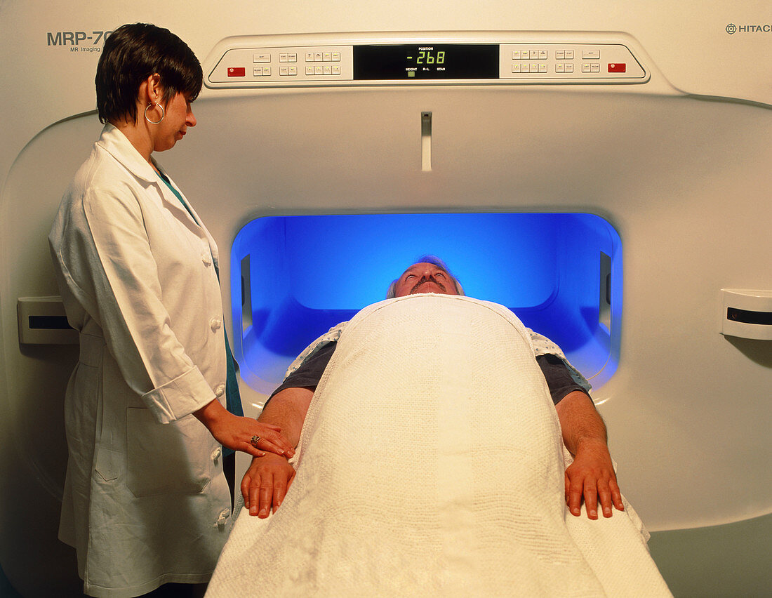 Man in wide MRI scanner for claustrophobics