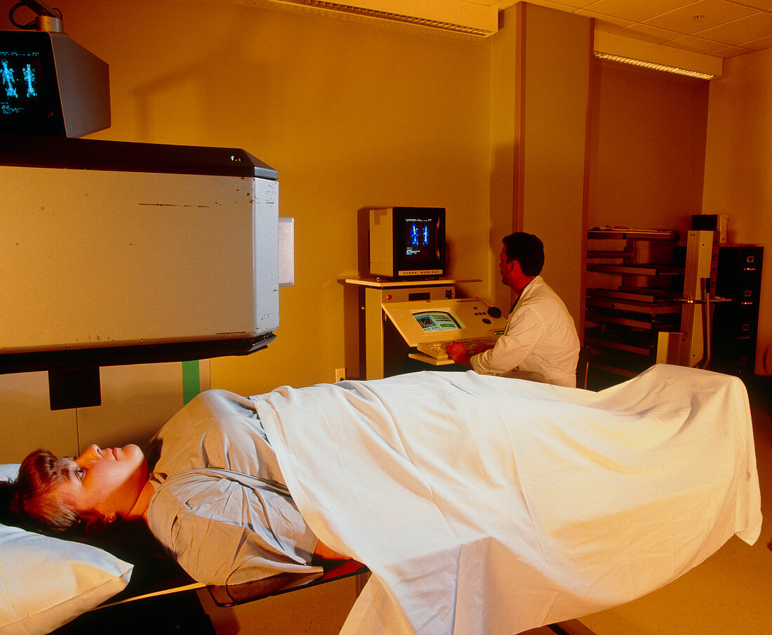 Woman undergoing bone gamma scan to detect cancer