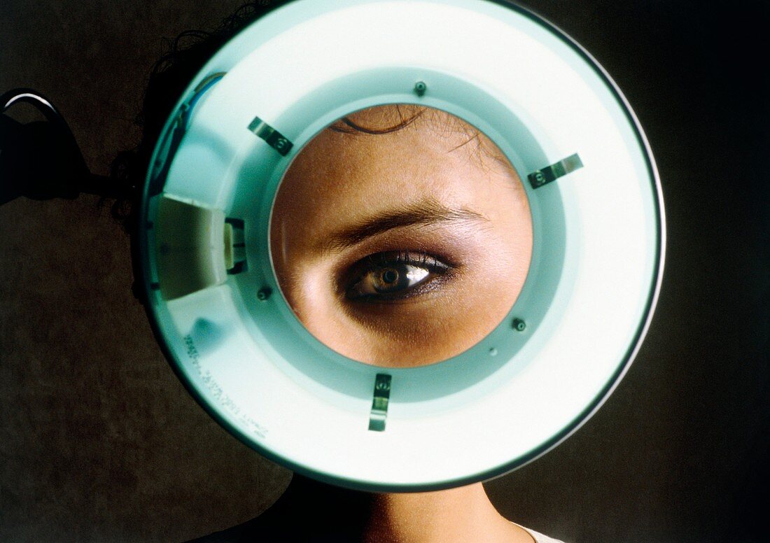 Young woman's eye magnified during eye examination
