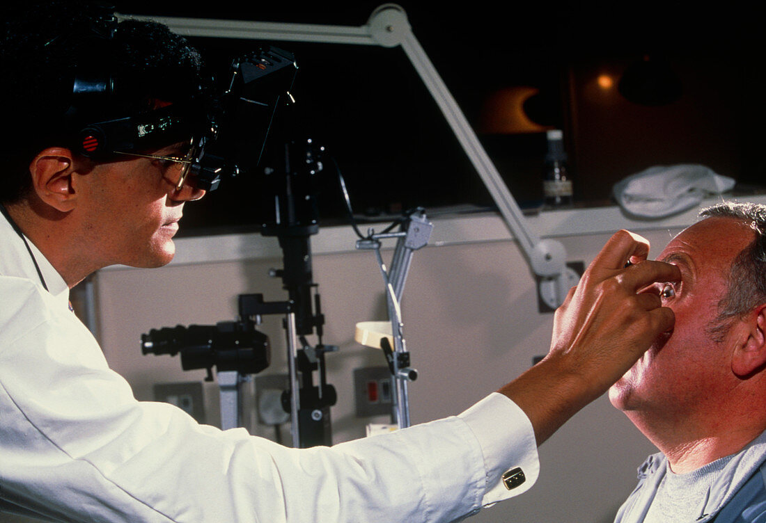 Indirect ophthalmoscope examination of a man's eye