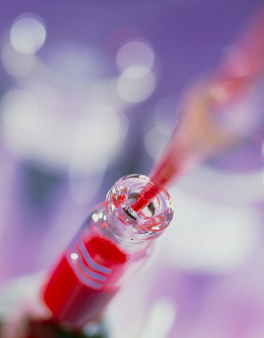 Blood sample being pipetted into a sample bottle