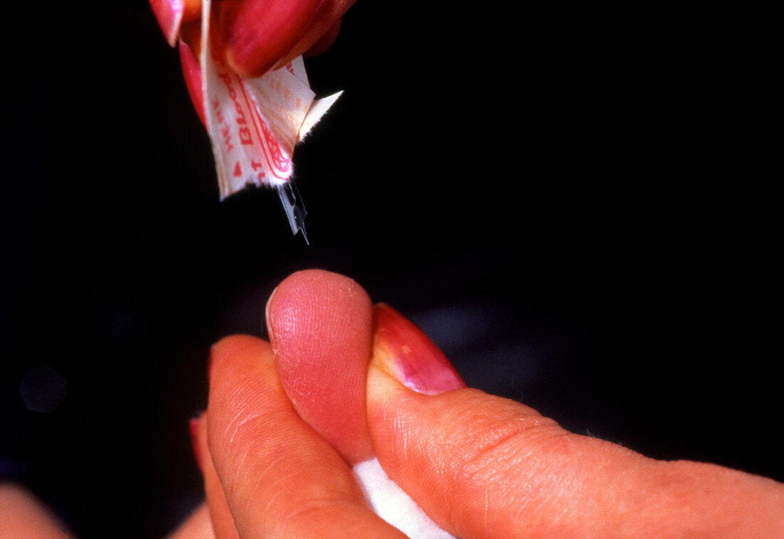 Pricking the finger to release blood sample