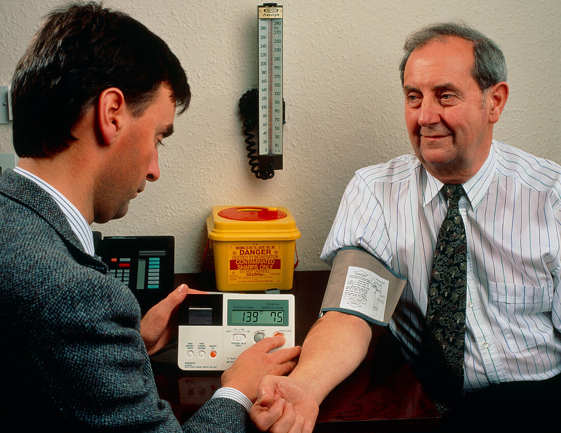 GP measures blood pressure with digital sphygmo