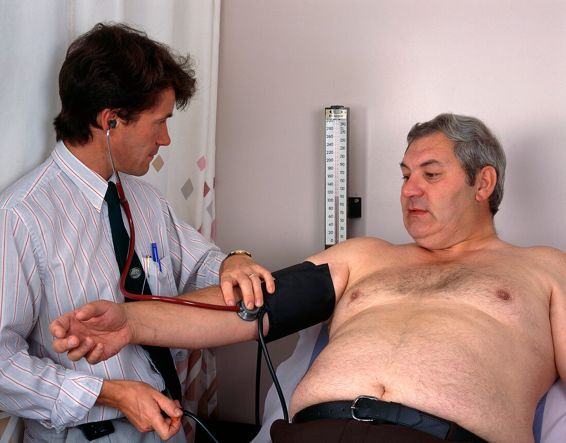 Doctor takes the blood pressure of an obese man