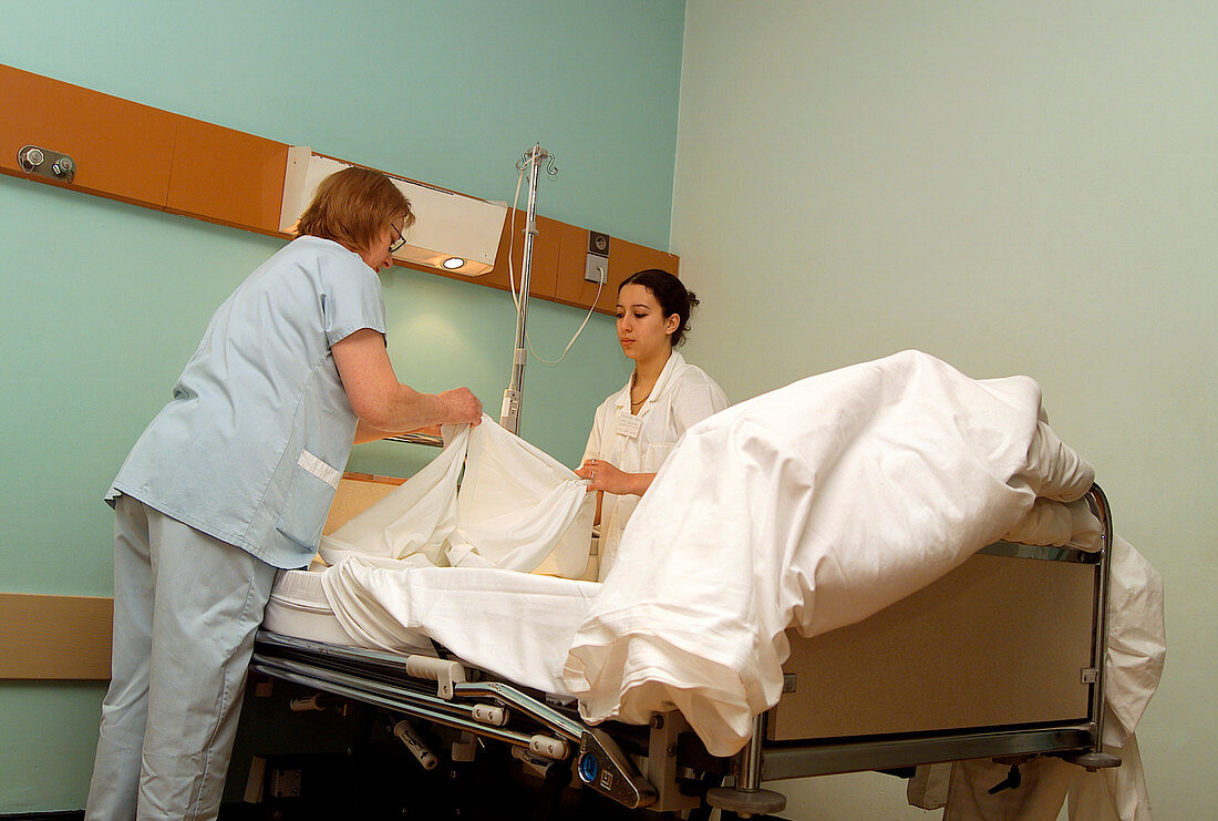 Nurses changing bedlinen