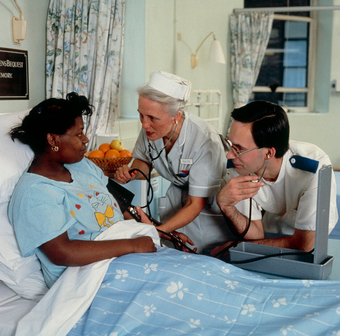 2 nurses checking patients blood pressure